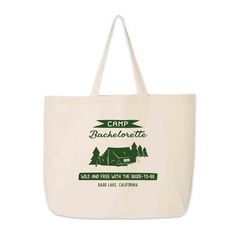 a white tote bag with the camp bachelorta logo on it