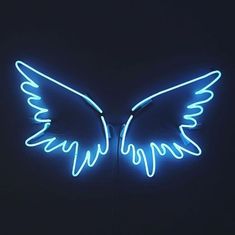 a neon sign with wings on it in the dark