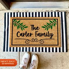 a door mat that says the carter family next to shoes on top of it and an orange sticker in front of it