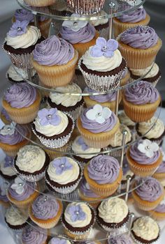 cupcakes are stacked on top of each other in the shape of a tower