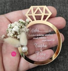 a person holding a ring with flowers in it