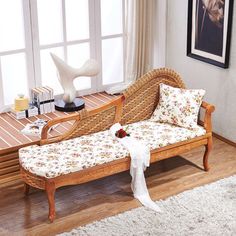 a wooden bench sitting on top of a hard wood floor next to a white rug