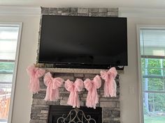 a flat screen tv mounted on top of a brick fireplace