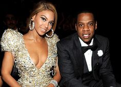 a man and woman sitting next to each other at a formal event in tuxedos