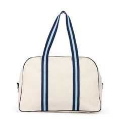 This chic canvas pickleball bag is a classic with its coordinating navy and light blue stripes and details. Made from durable natural canvas, this cute blue pickleball tote has a paddle pocket on the side (fits two paddles) and a roomy interior for all of your gear. Even better, it comes with a navy blue and light blue striped crossbody/shoulder strap so you can carry it in three different ways as you head for the pickleball courts. The exterior pocket can fit two pickleball paddles and includes Golf Shoe Bag, Tennis Backpack, Neoprene Bag, Tennis Accessories, Tennis Bags, Shoe Bags, Tennis Clothes, Paddles, Blue Canvas