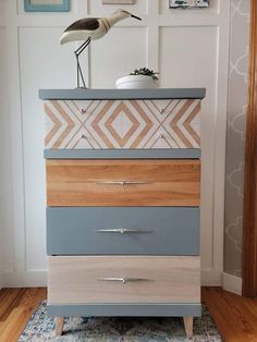 a bird is sitting on top of a dresser