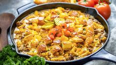 a skillet filled with pasta and vegetables