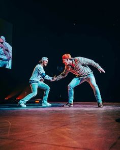 two people on stage with one holding the other's hand