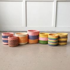 several woven baskets lined up on the floor