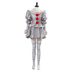 a woman in a clown costume is standing on a mannequin's head