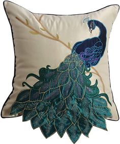 a decorative pillow with a peacock on it