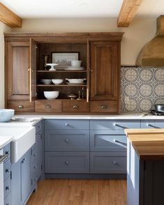 a kitchen with wooden cabinets and white counter tops