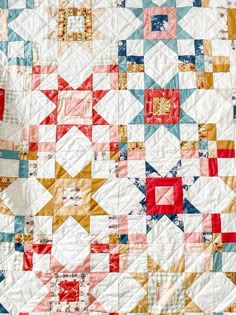 a quilt made with red, white and blue squares