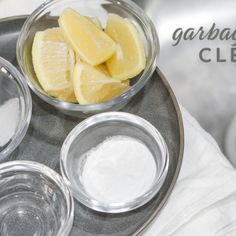 some lemons and sugar are in bowls on a plate with the words garbana clean