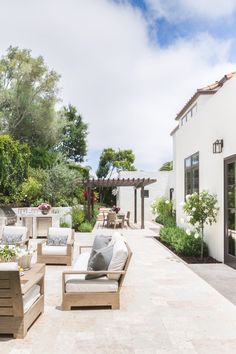 an outdoor living area with patio furniture and trees