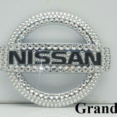 an image of a nissan emblem with diamonds in the middle and on the bottom, surrounded by words that read grand