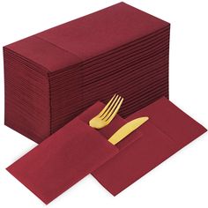 a stack of red napkins with gold forks