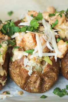 baked potatoes with shrimp and parmesan cheese on top are ready to be eaten