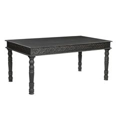 a black table with wooden legs and an ornate design on the top, against a white background