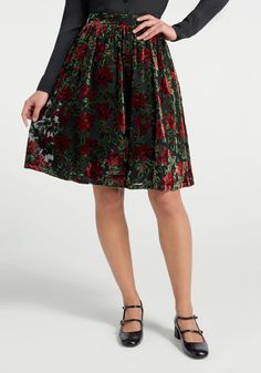 Covered throughout in a red and green menagerie of holly and poinsettias, this 50’s-inspired velvet skirt from our ModCloth namesake label is truly timeless!! Made from a soft and drapey black velvet, this A-line skirt features nifty hidden pockets, an elasticized panel at the back for ease-of-fit, and retro-chic below-the-knee finish that is so much fun to mix-and-match for all your festive holiday events!100% Polyester Velvet DevoreFabric does not provide stretchElastic panel at back provides stretchFully-linedSide pocketsFits true-to-sizeImportedModel Measurements:HEIGHT  173 cm / 5'8"BUST  81 cm / 32"WAIST  64 cm / 25"HIPS  90 cm / 35.5"DRESS: XS/2 US Holiday Party Pants, Velvet Bottoms, Plus Size Vintage Clothing, Dark Floral Dress, Designer Plus Size Clothing, Cute Red Dresses, Maximalist Fashion, Holiday Skirts, Luxury Loungewear