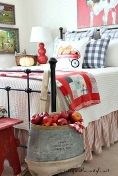 a bed room with a neatly made bed and a basket of fruit on the floor