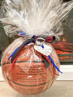 a basketball wrapped in plastic and sitting on top of a counter