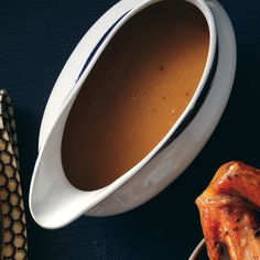 a white bowl filled with soup next to chicken wings