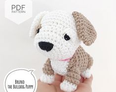 a small crocheted dog is sitting on someone's hand with the text below it