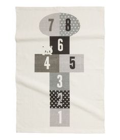 a white towel with numbers on it and dots in the middle, along with an image of a cat