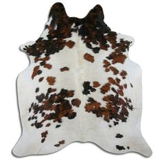 a cowhide rug with brown and white spots