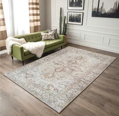 a living room with a green couch and rug