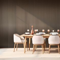 a wooden table topped with white chairs next to a vase