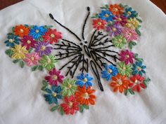 an embroidered butterfly with colorful flowers on it