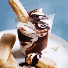 an ice cream sundae with chocolate sauce and cookies