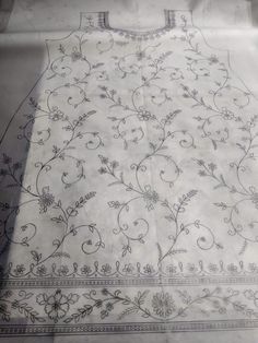 a white table cloth with floral designs on it