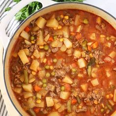 a pot filled with meat and vegetables on top of a table