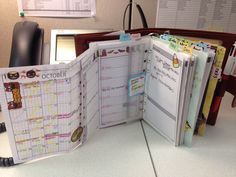 an open planner book sitting on top of a desk