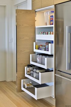 an organized pantry in the corner of a kitchen