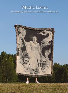 a woman standing in front of a large blanket with an image of jesus on it