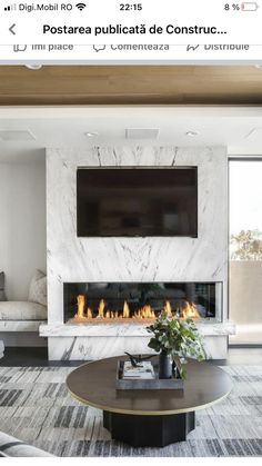 an image of a living room setting with fireplace and flat screen tv on the wall