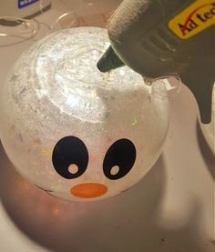 a close up of a snowman ornament on a sink