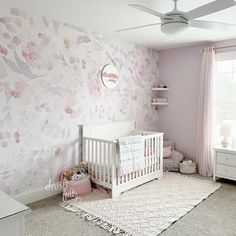 a baby's room with pink and white decor