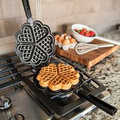 some waffles are sitting on top of the gas burner in the kitchen