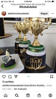 two trophies sitting on top of a table next to plates and bowls with food in them