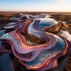 an artisticly designed building in the desert with wavy lines on it's roof