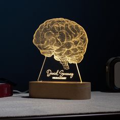 the illuminated brain lamp is sitting on a table