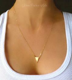 Gold Chevron Geometric Triangle Necklace With a sleek style this modern necklace features one small triangle and genuine dainty pyrite. Looks fabulous alone or layered with other necklaces. Three pyrite stones are a mix of gold and silver Triangle is 15mm and is gold plated brass Chain is a lightweight and sparkling 14k gold filled chain Necklace closes with a 14k gold filled spring clasp Necklace is shown at 20" - Choose the perfect length for you Need a pair of matching earrings? See them here Chevron Jewelry, Petite Necklace, Pyrite Necklace, Chevron Earrings, Arrow Earrings, Modern Necklace, Chevron Necklace, Gold Chevron, Triangle Necklace