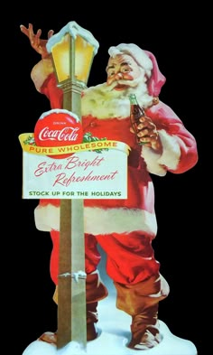 a santa clause holding a beer standing next to a street sign