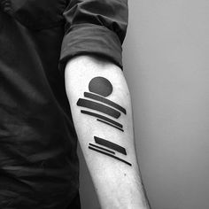 a man with a black and white tattoo on his arm that has lines in it