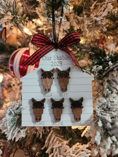 a christmas ornament hanging on a tree with three little deers in it